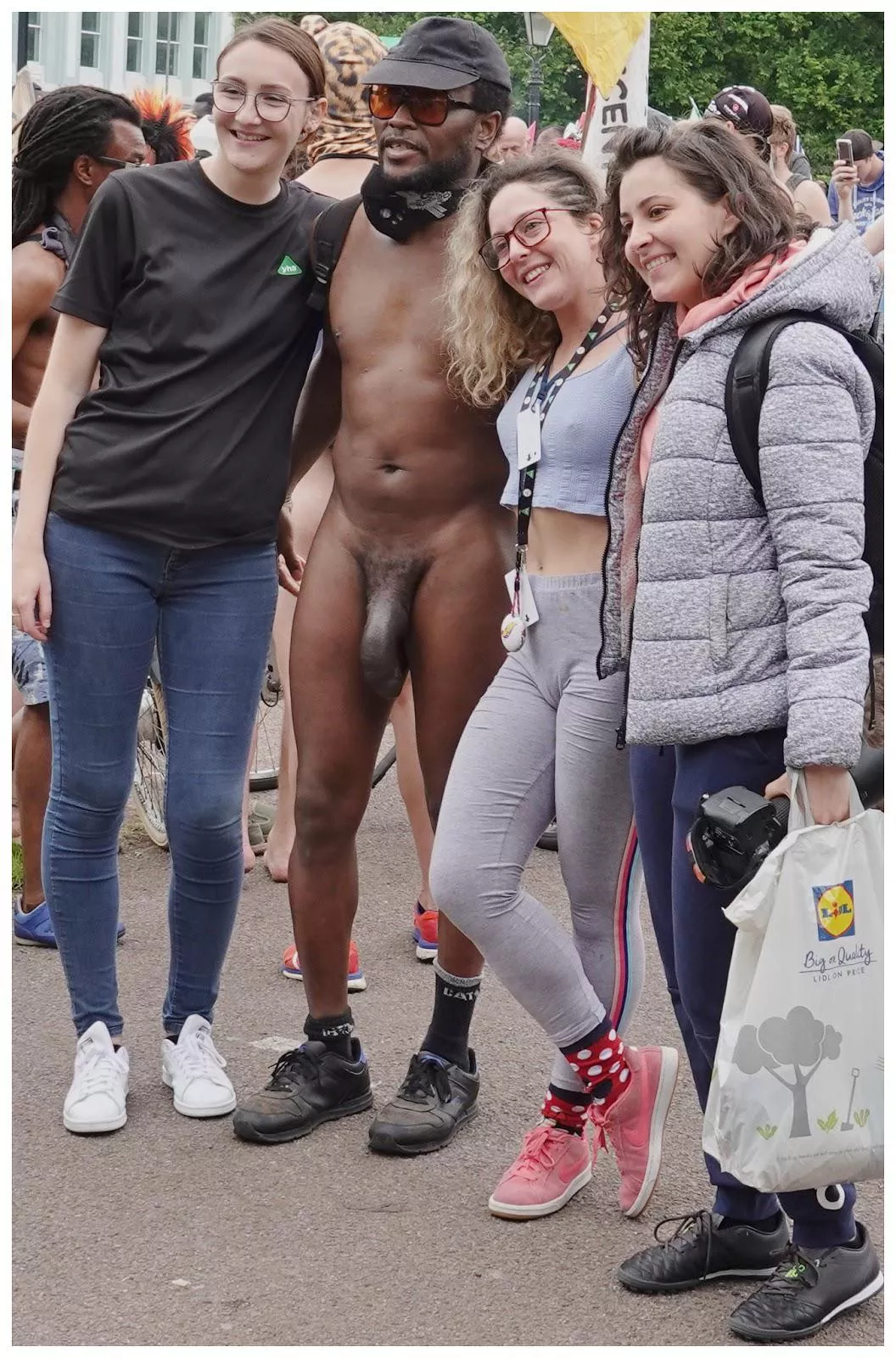 3 girls enjoy posing with a huge dick at WNBR cfnm