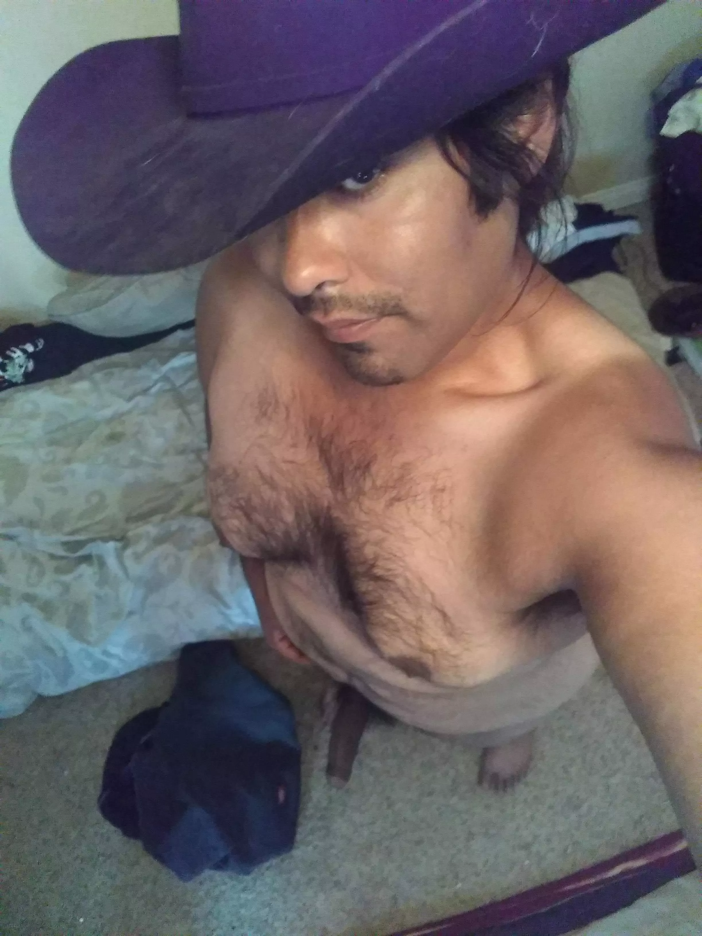 A gothic cowboy with a hairy chest