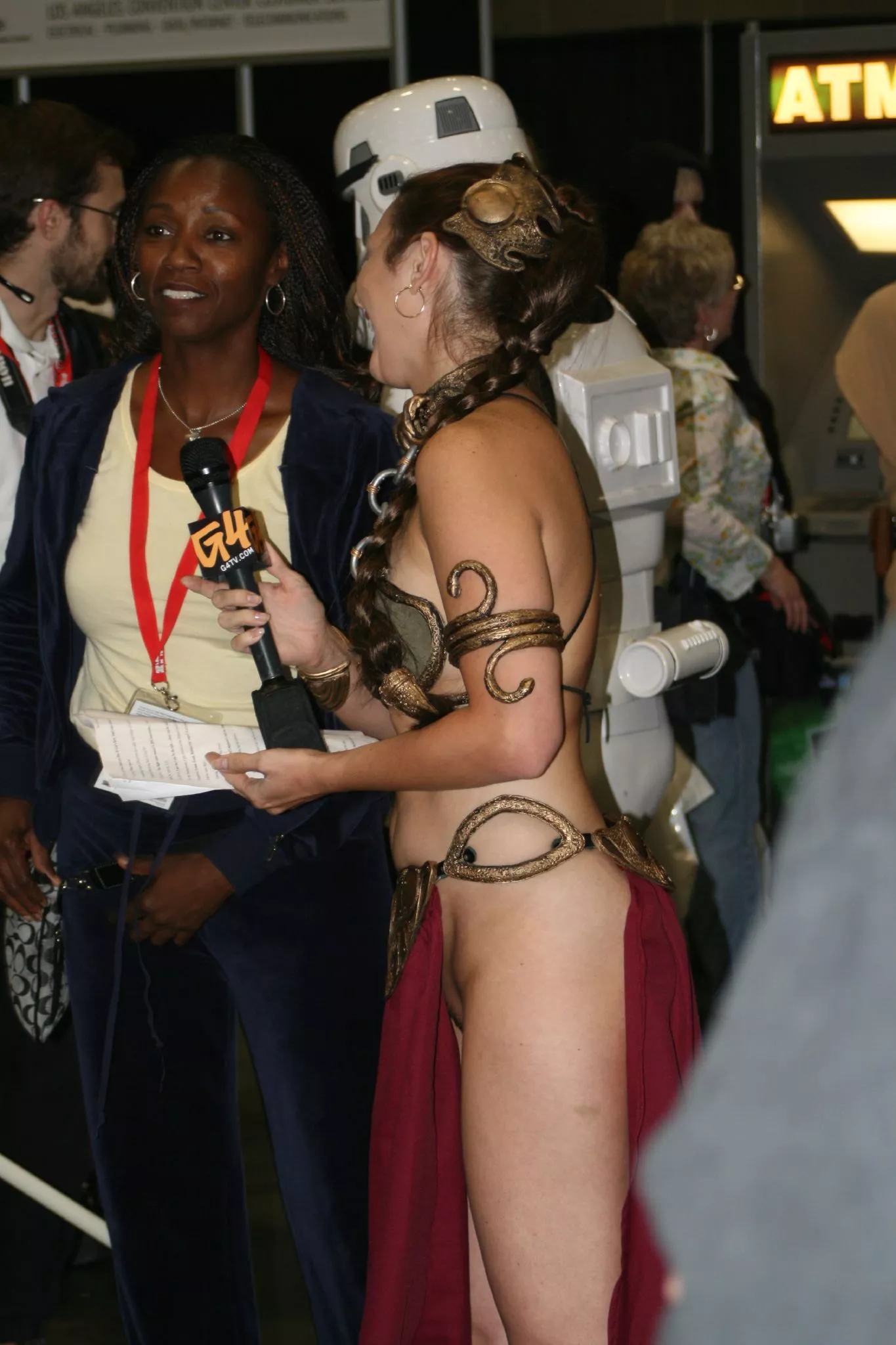 A reporter dressed as Slave Leia at an event