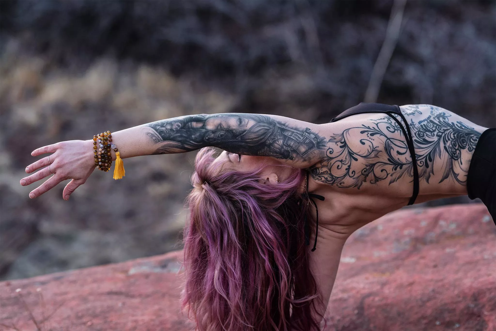 Beautiful tattooed alternative yoga girl with a heart opener. How about that purple hair?