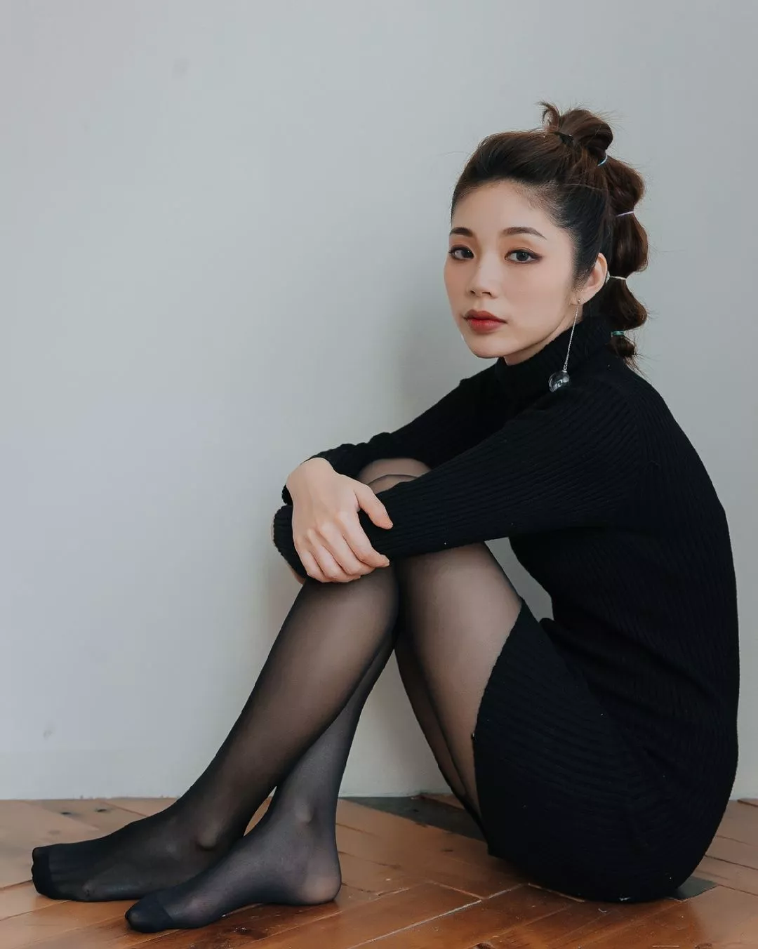 Black sweater dress and feet in black nylons