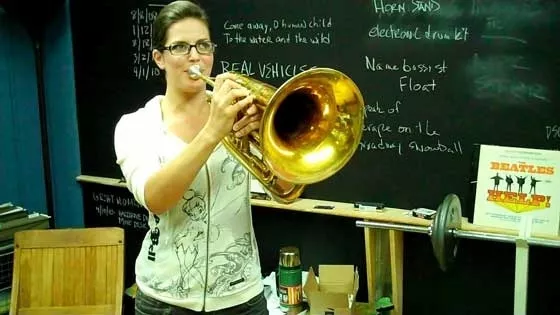 Bobbi blowing (a trumpet)...