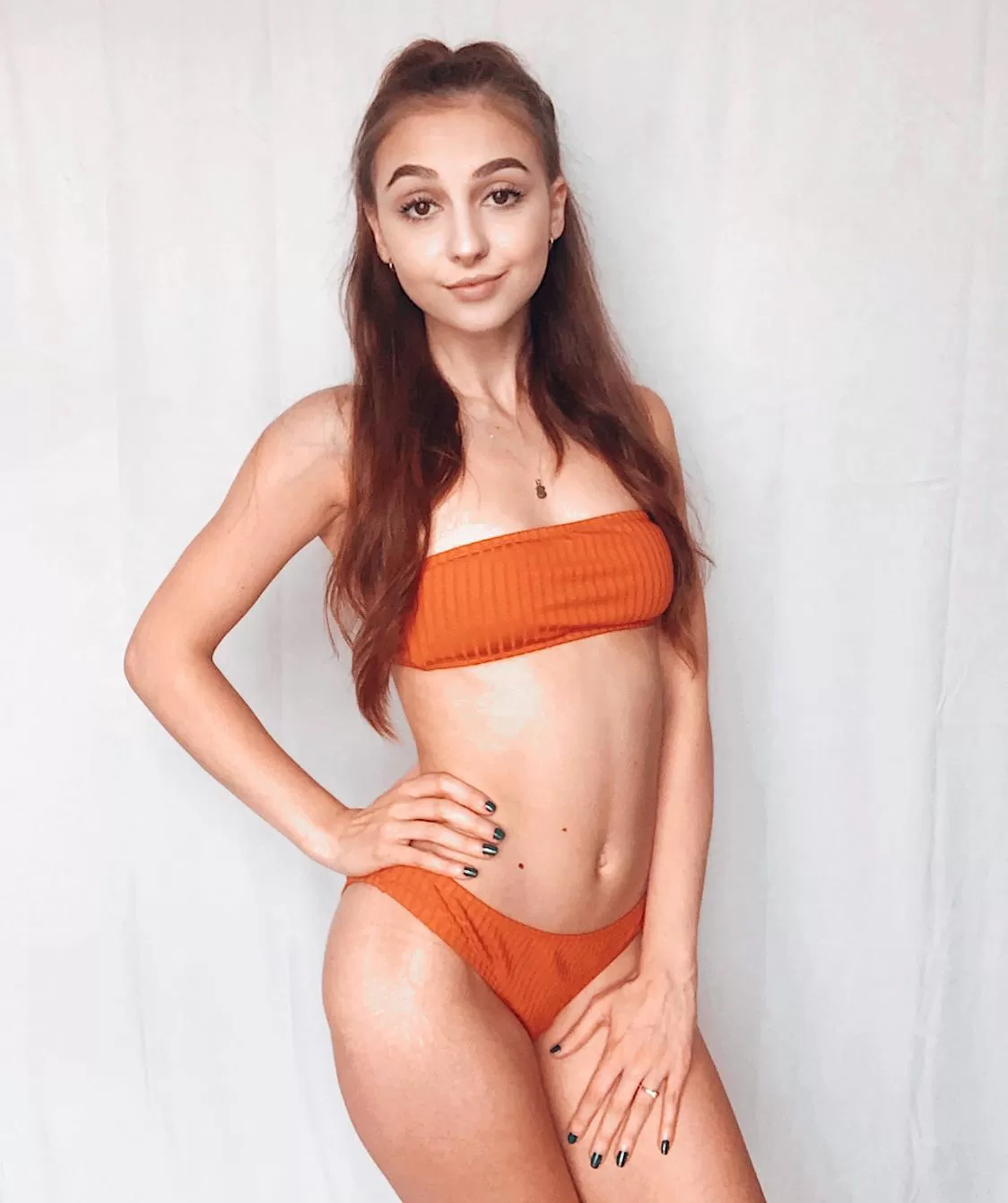 Brunette girl in an orange bikini 🍊