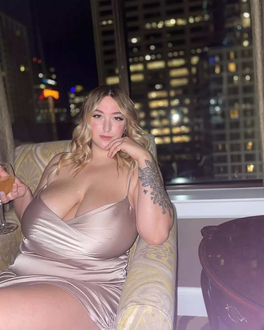 Busty blonde going braless in a champagne dress