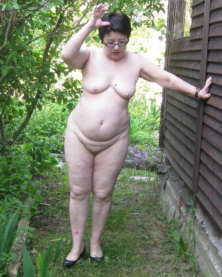 Chubby mature nudist walking around the house