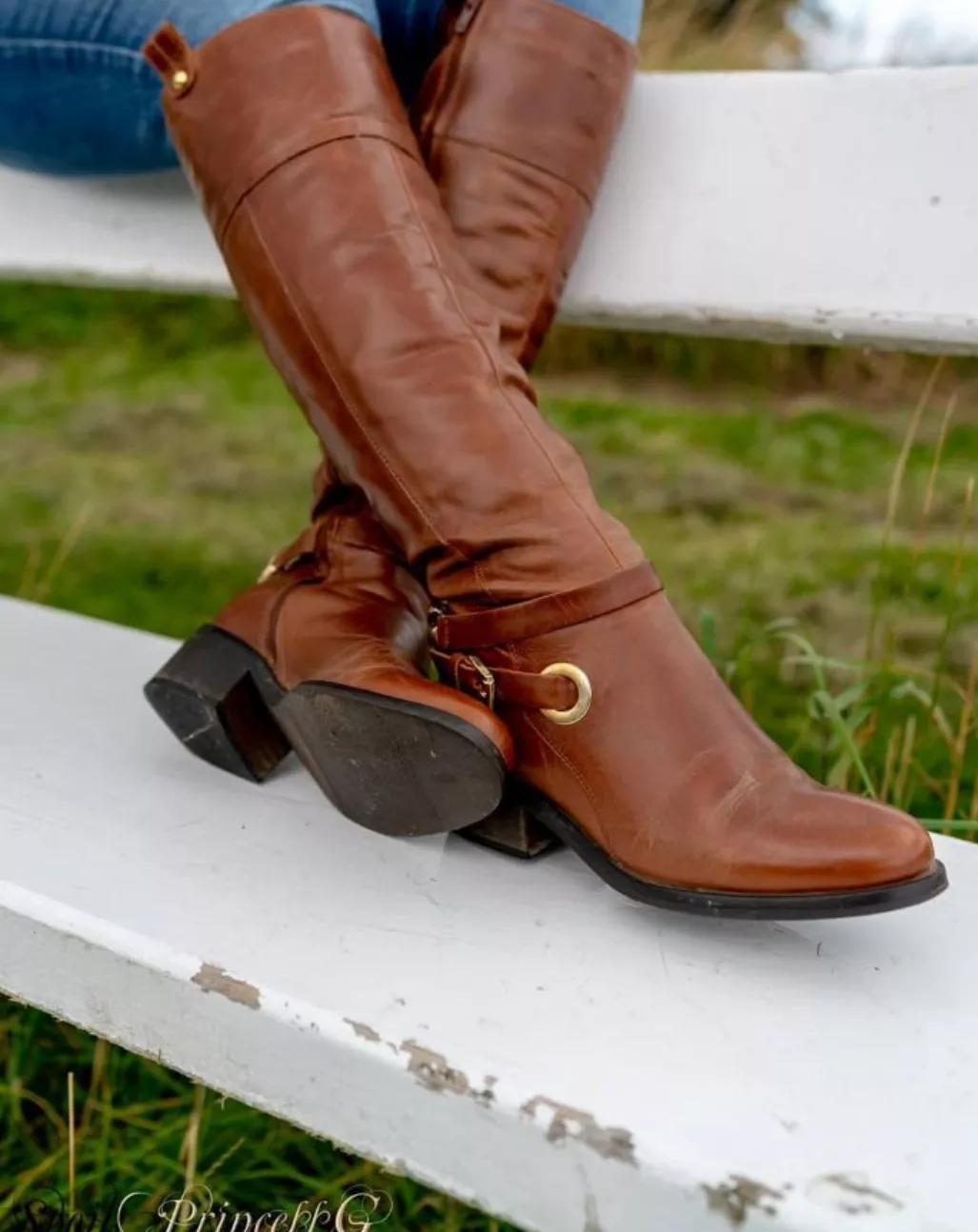 Classic brown leather riding boots and jeans.