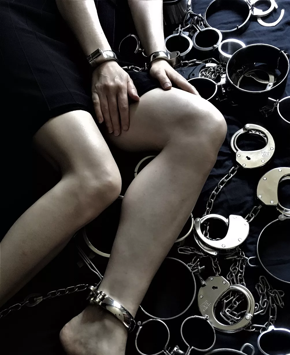 Cuffed and lying on (part of) the restraint collection