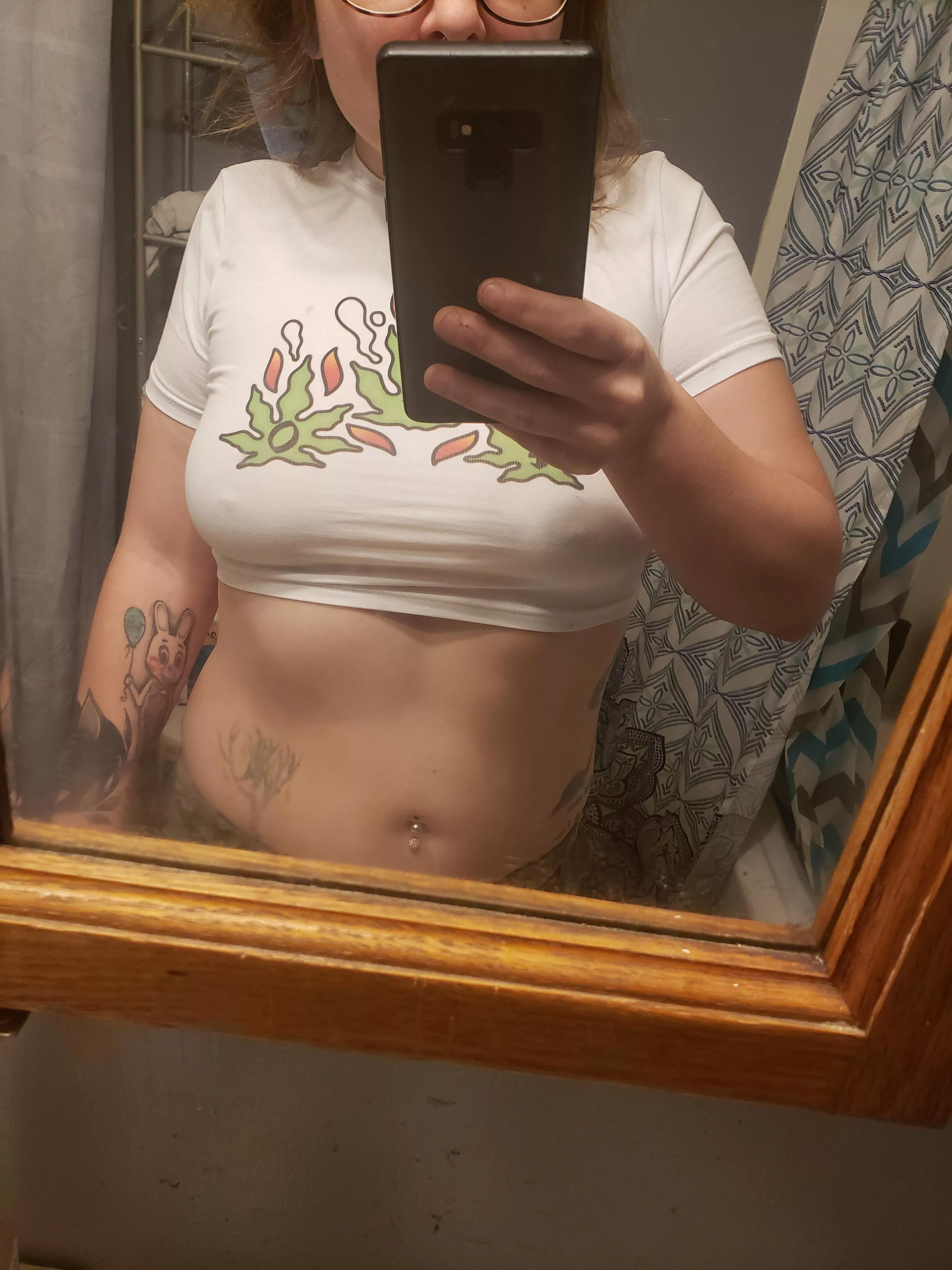 Double navel piercing and hard nipples poking through t-shirt.