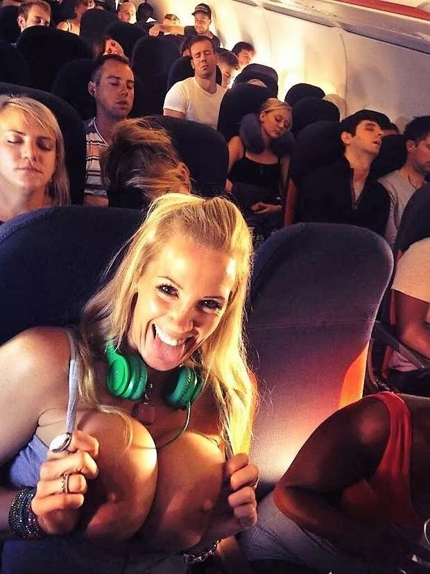 Flashing her bimbo tits on the plane