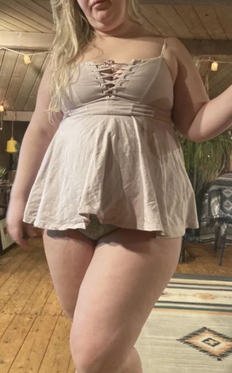 Her stomach and ass have gotten so large that her dress is now short enough to see her panties from the front.