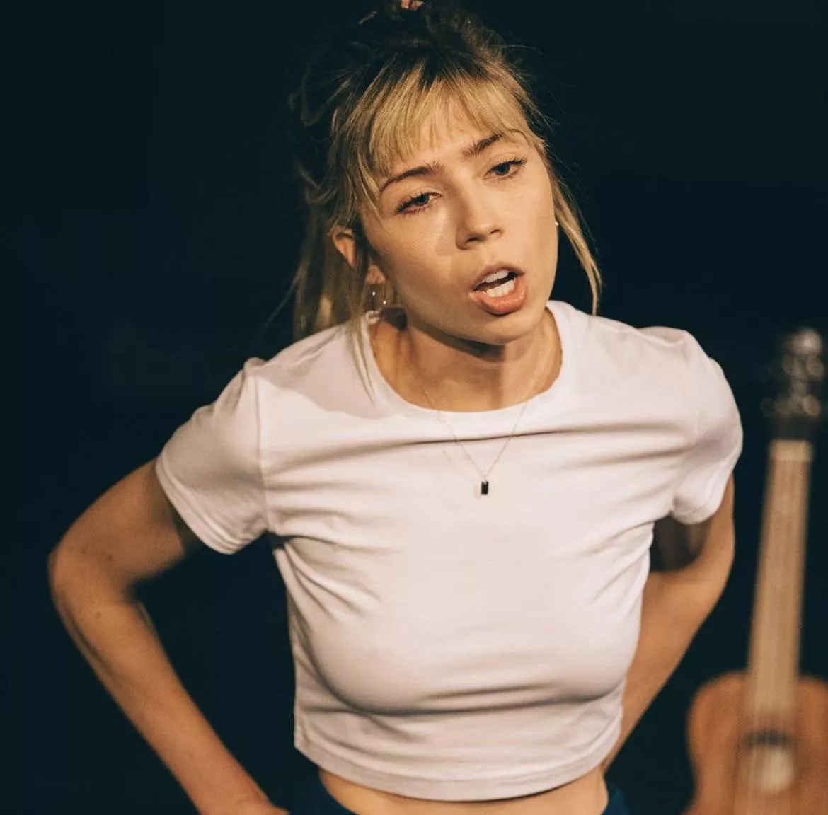 Jennette McCurdy poking through a white top