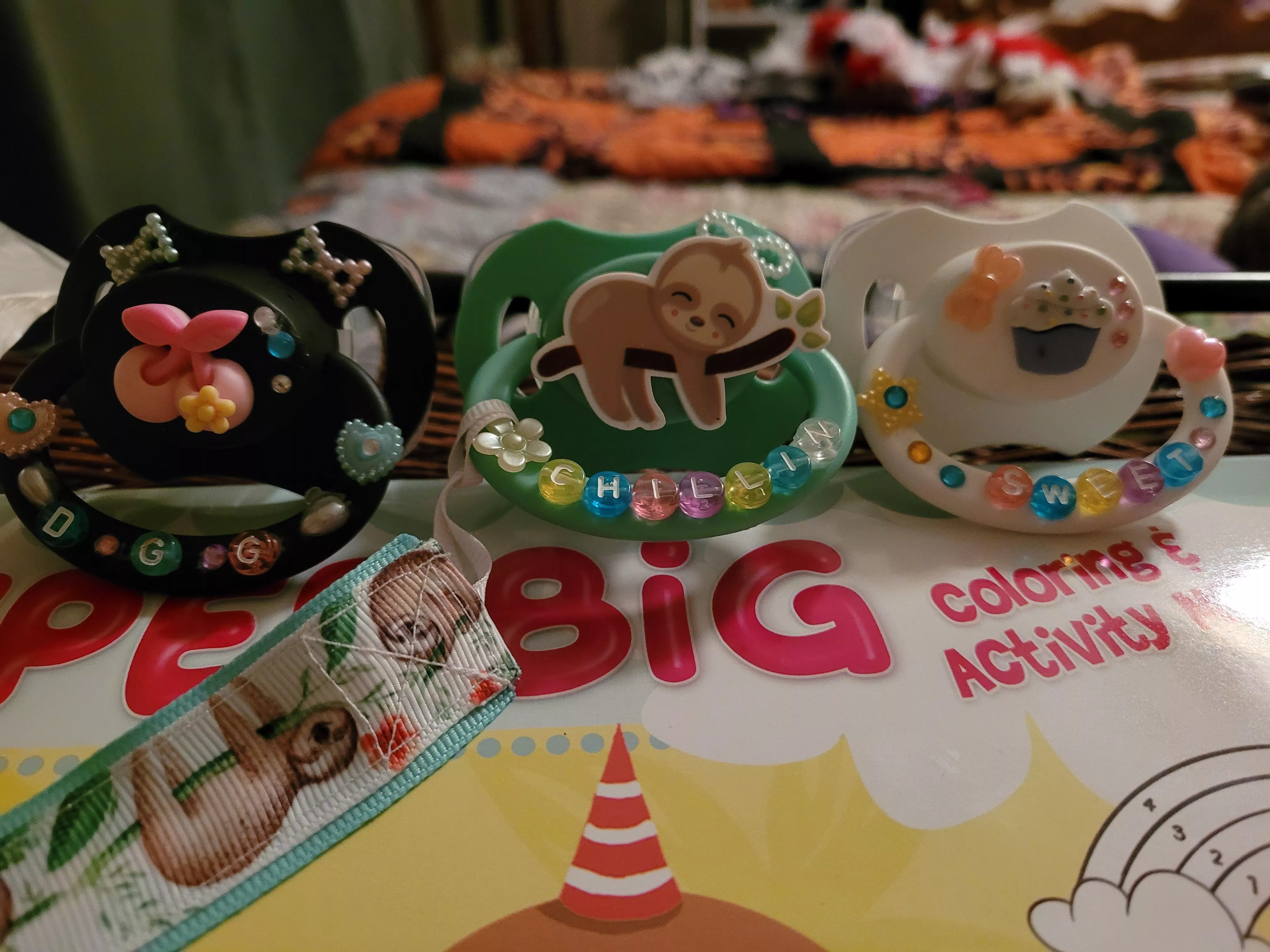 My new paci's. I made the cupcake one and Daddy made the cherry one. Funny daddy says he wants to make me a couple more.