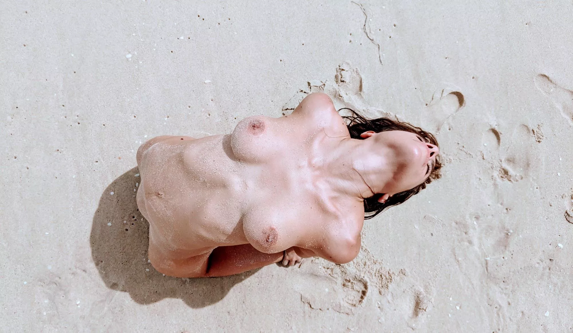 Nude yoga pose at the beach, seen from up above!