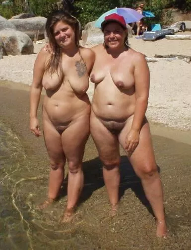 Pair of plump nudists on the beach