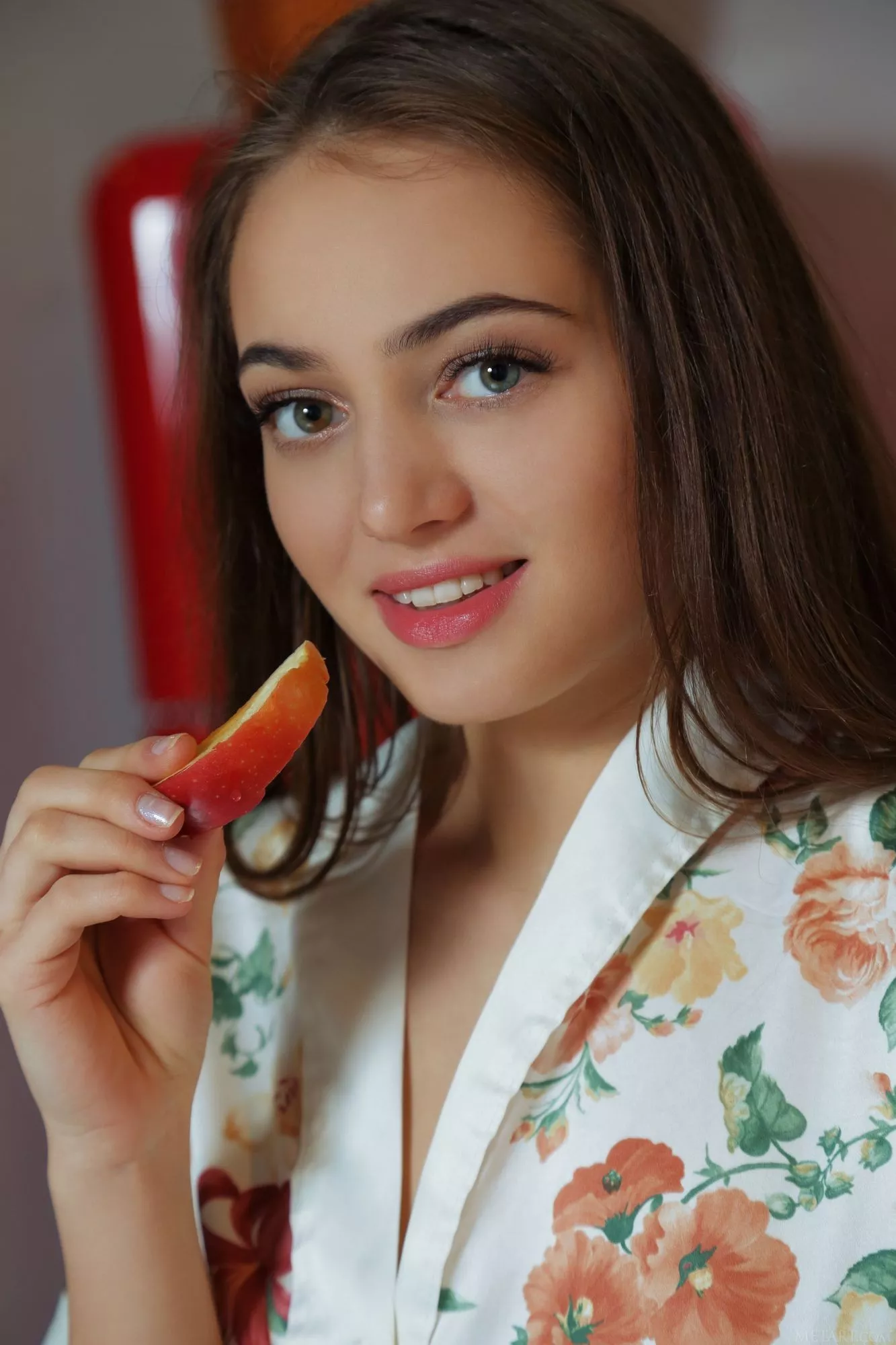 Pretty girl with slice of apple