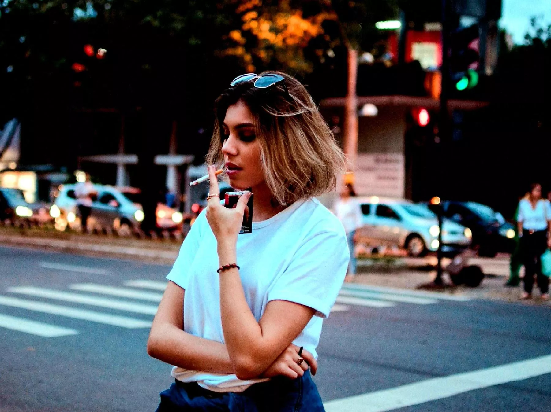 Sexy girl smoking and crossing the street