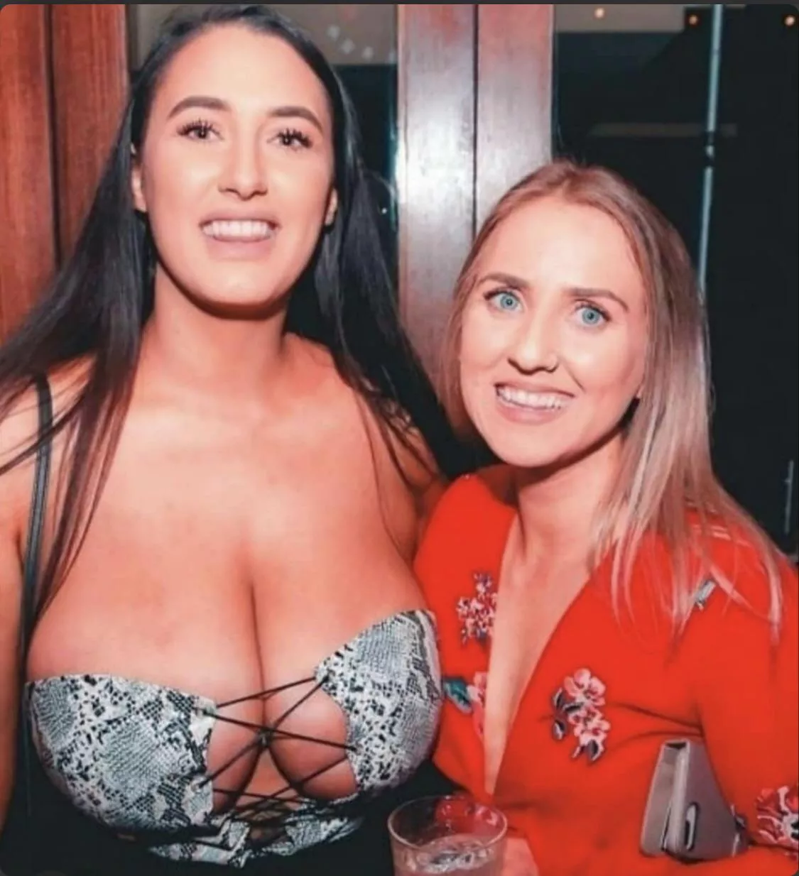 She’s so embarrassed she’s trying to hide her boobs behind her friends’