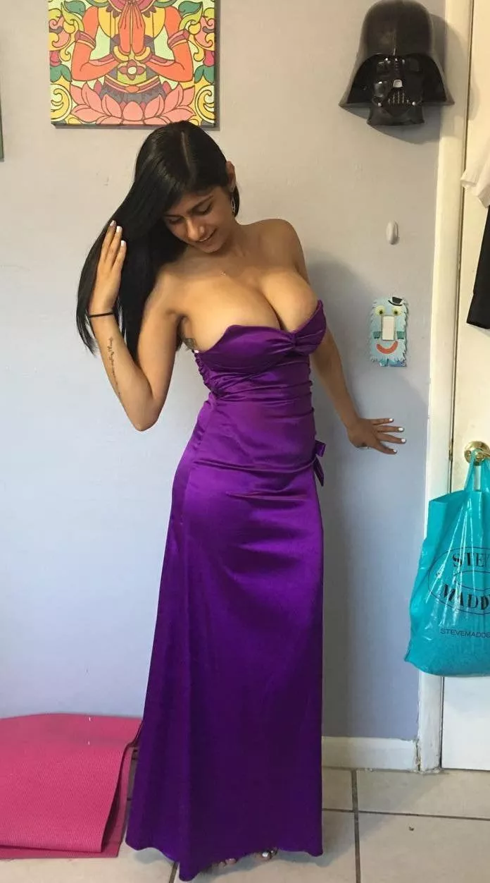 Spilling out of her dress