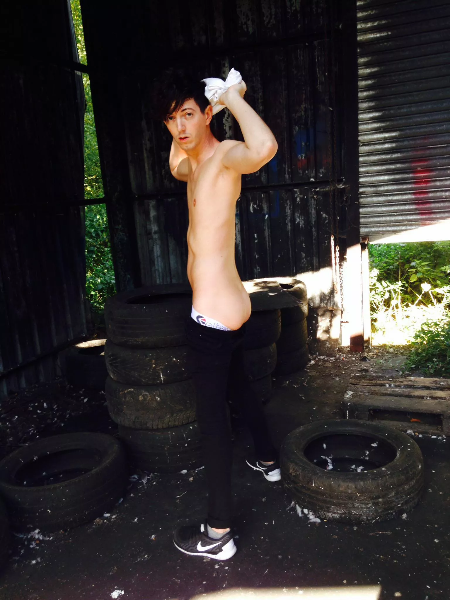 We found an abandoned garage in the middle of a large woods (England UK) so shot some impromptu pics on my phone. My boy got totally naked. I fucked him while he jacked off over the condom-littered floor. Must be a fun place to visit on a night. 😈