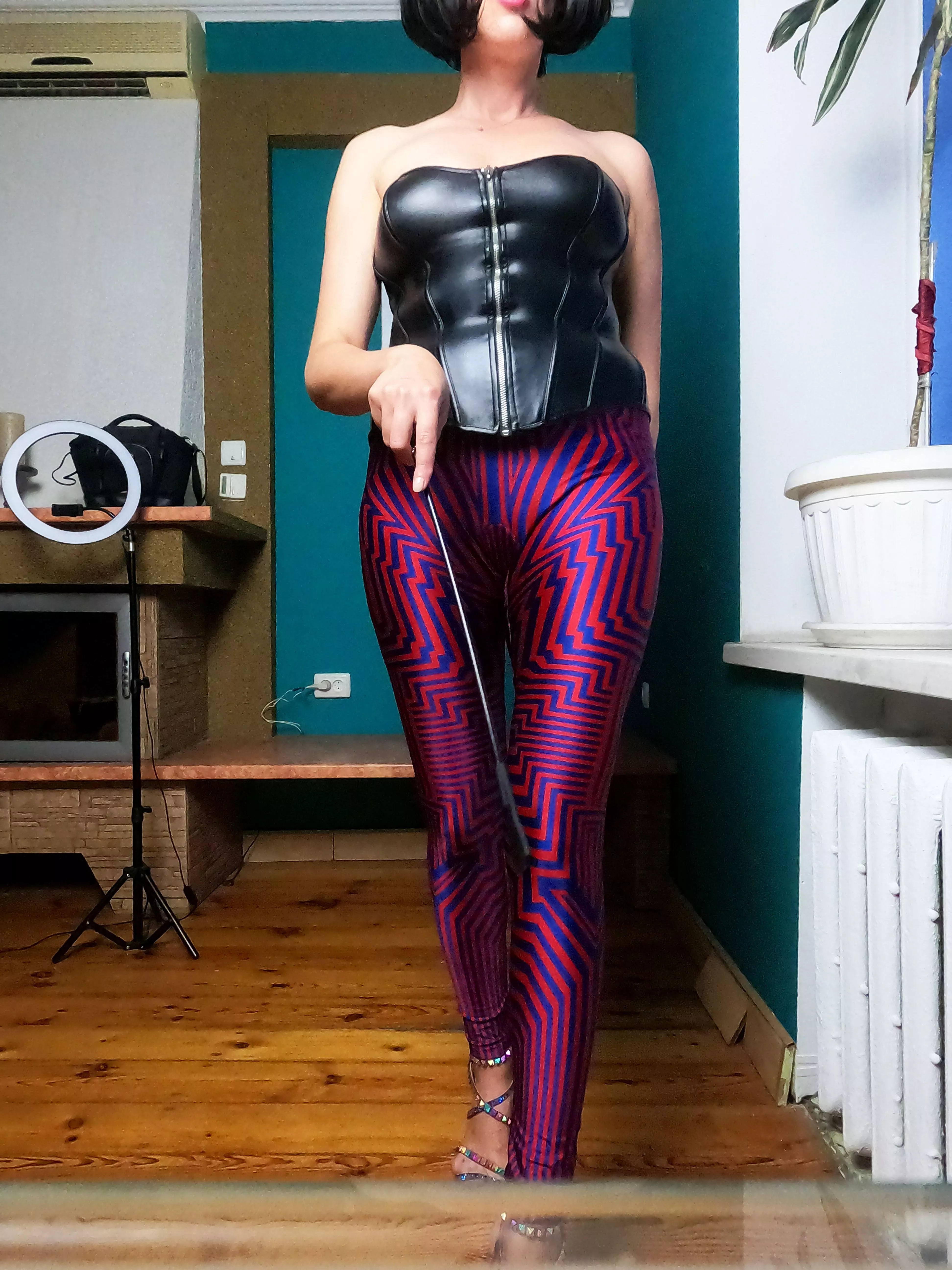 Wearing bright silky leggings and leather corset, can you resist?