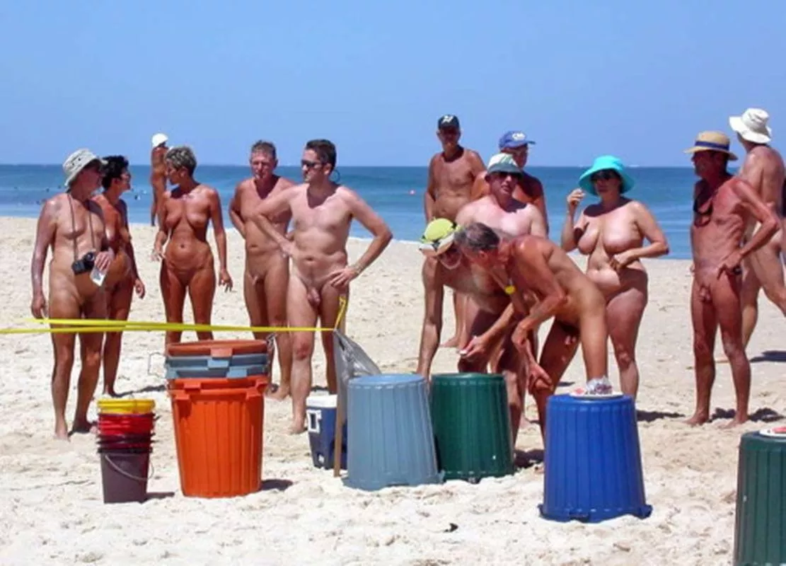 What a crowd of elderly people could be doing with a stack of trash bins?