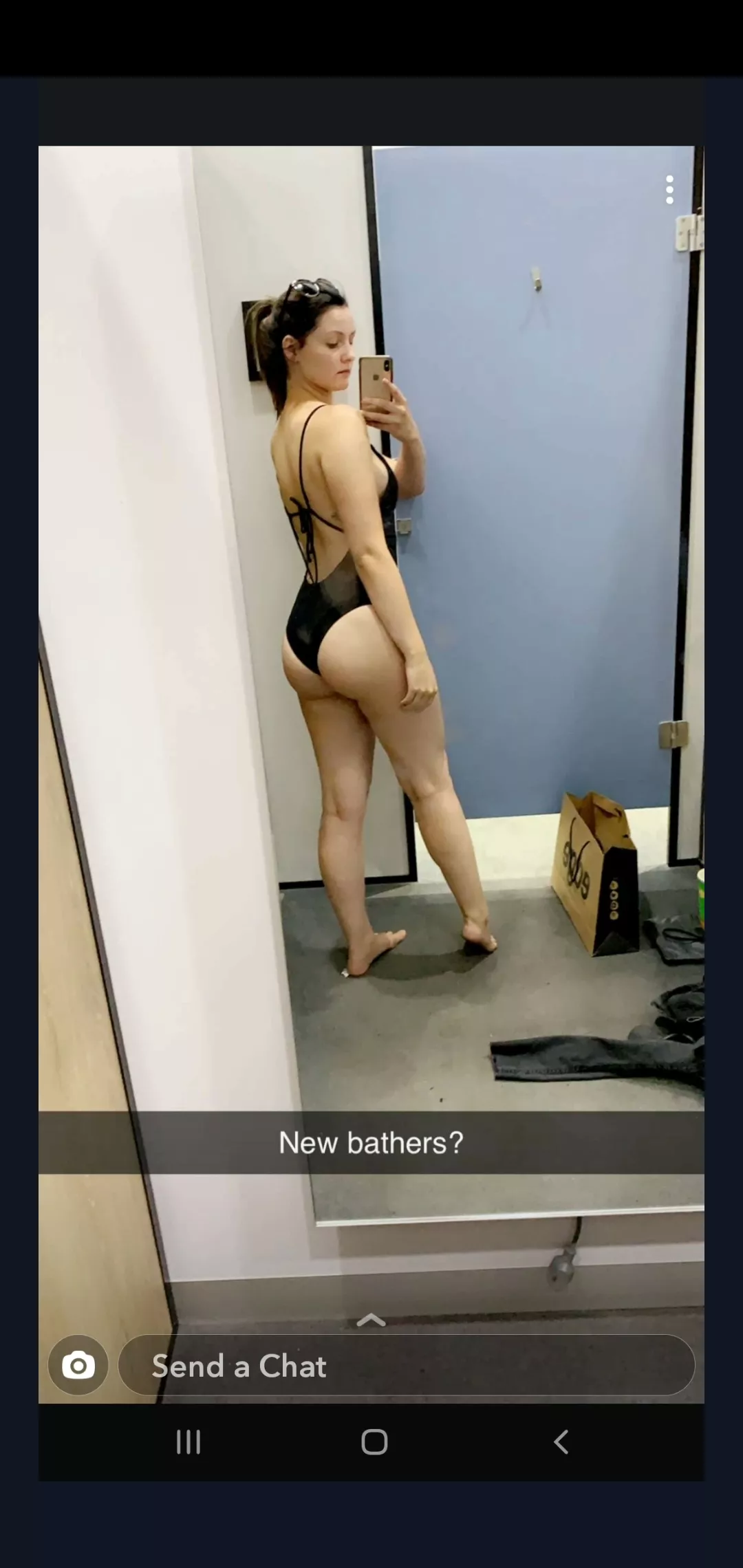 Wife trying on new swimsuit