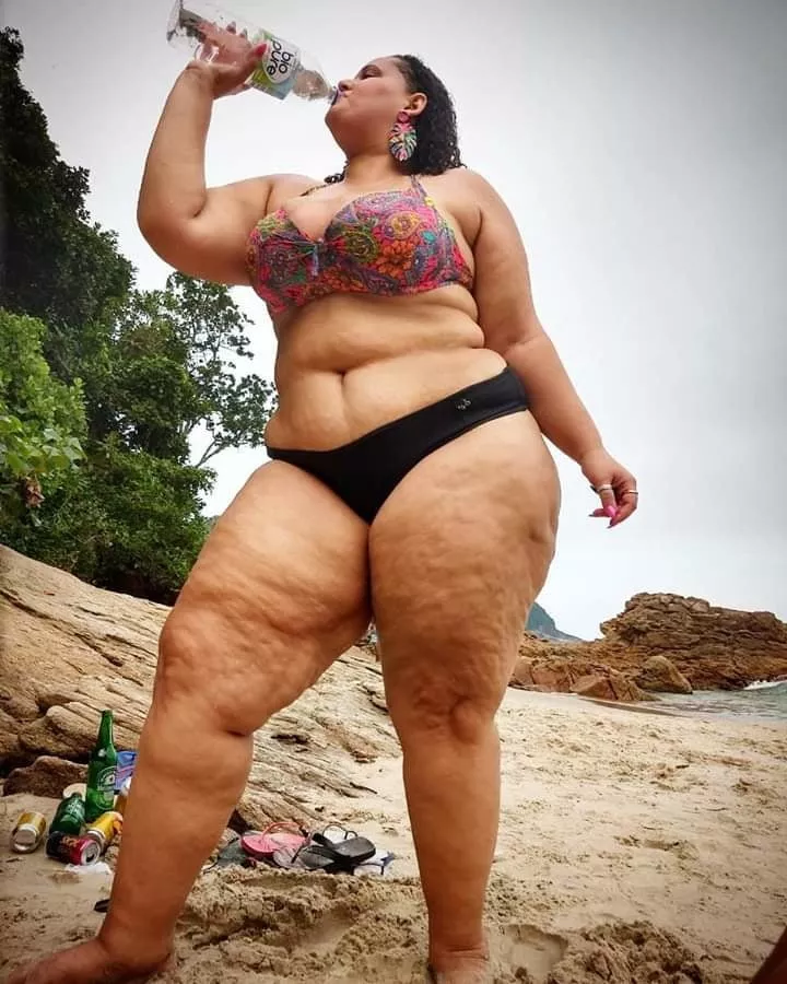 Woman Drinking A Soft Drink Has Cellulite On Her Thighs